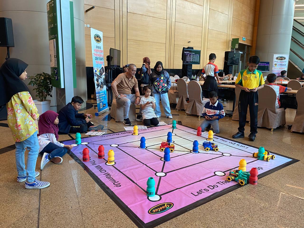 Robotic Goolee and a large-format game board set up for play